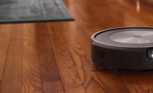 Roomba j7+ robot vacuum on hardwood floor