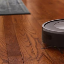 Roomba j7+ robot vacuum on hardwood floor