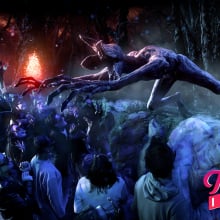 A creature from Stranger Things lunges over an audience wearing 3D glasses.
