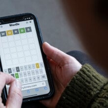 A close-up of someone playing Wordle on a smartphone.