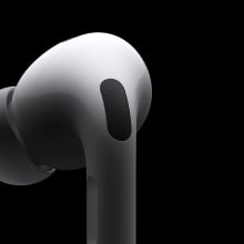 One AirPod Pro on a black background